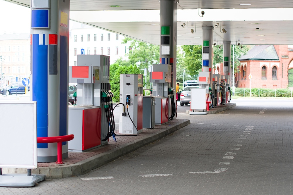 Commercial gas station pumps under an overhead canopy, representing a high-risk property type for environmental site assessments.